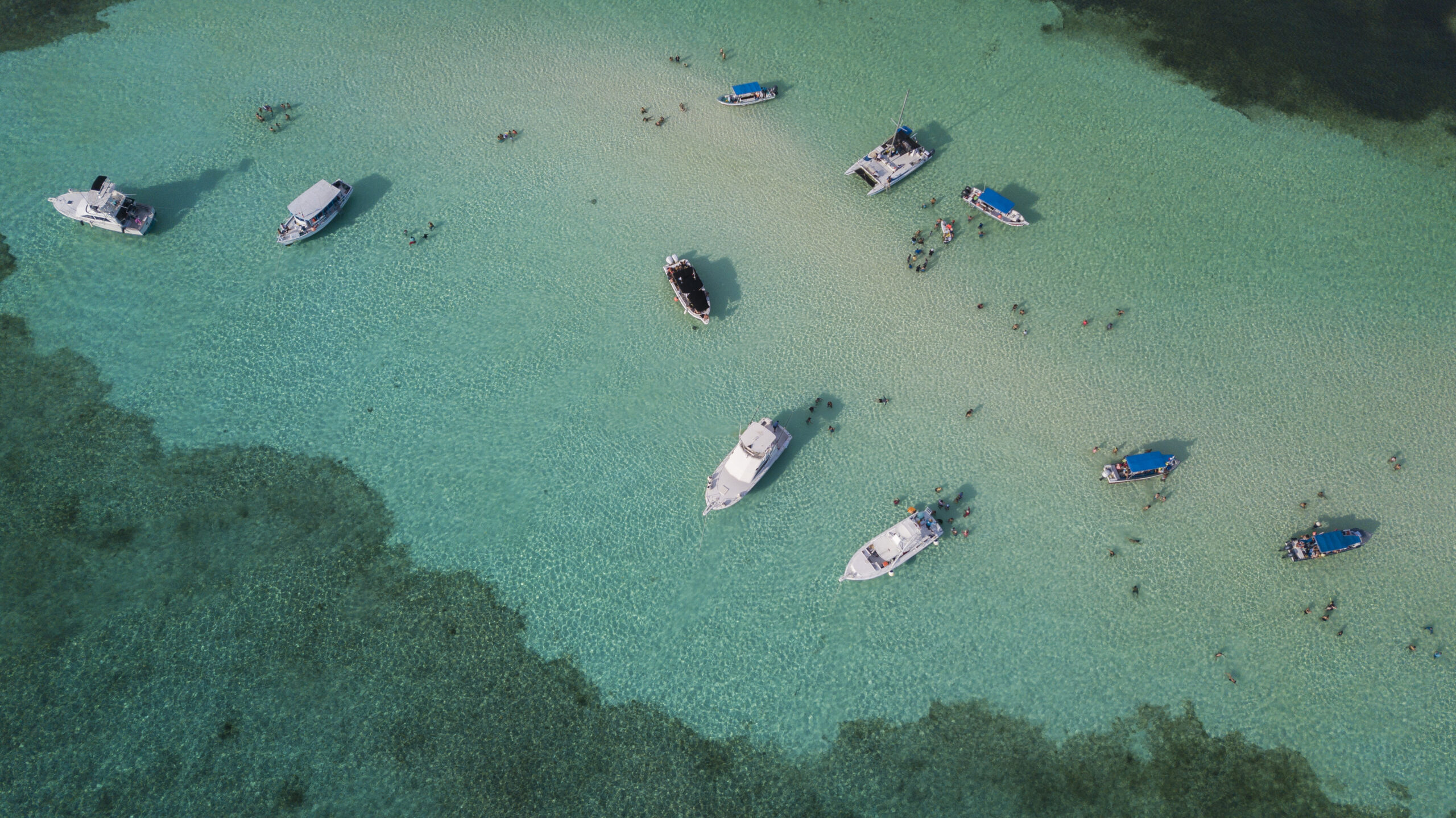 Aerial view of boats in the turquoise shallows of Cozumel